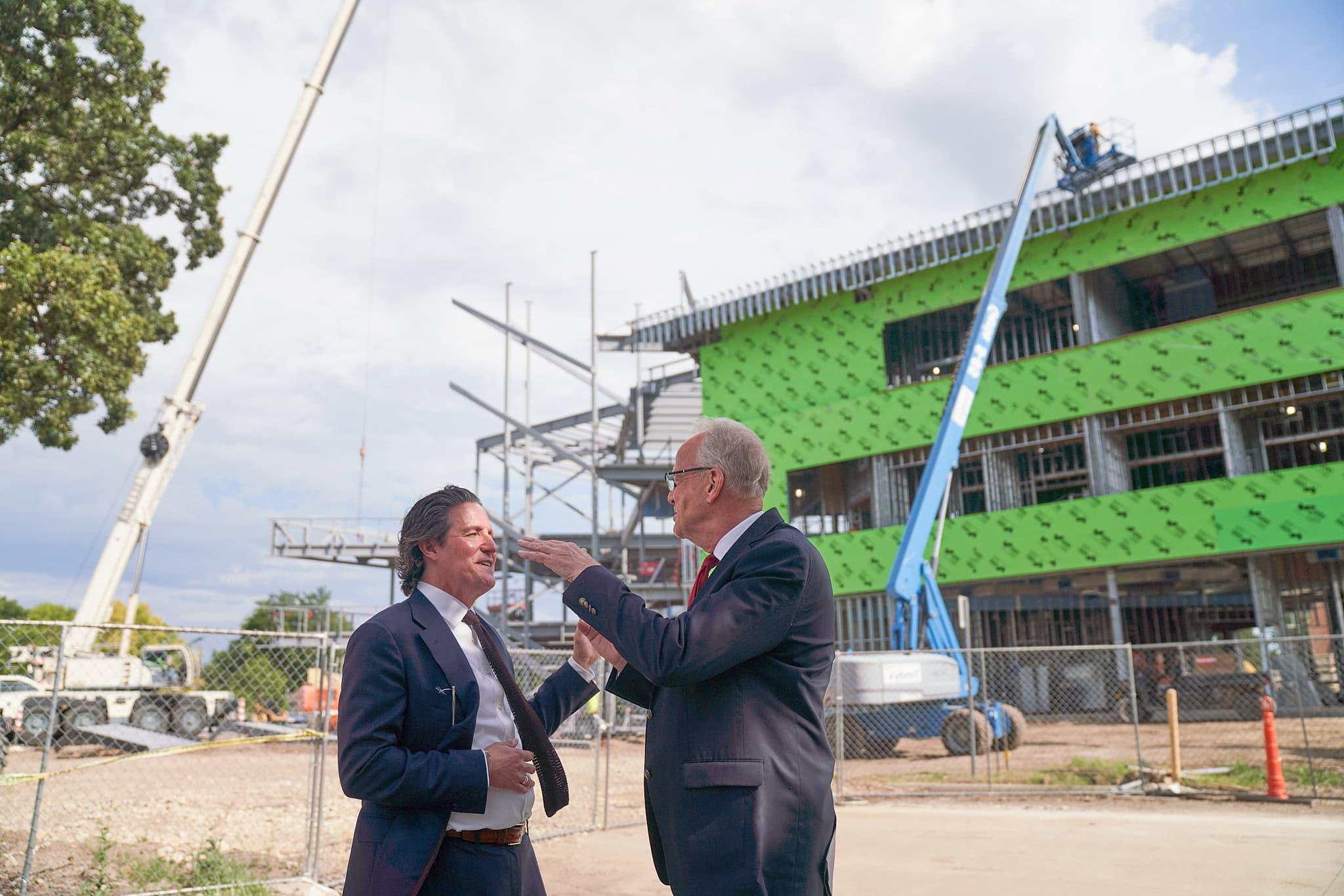 U.S. Senator Jerry Moran visits with McPherson College President Michael Schneider outside of the construction site for the new Campus Commons.